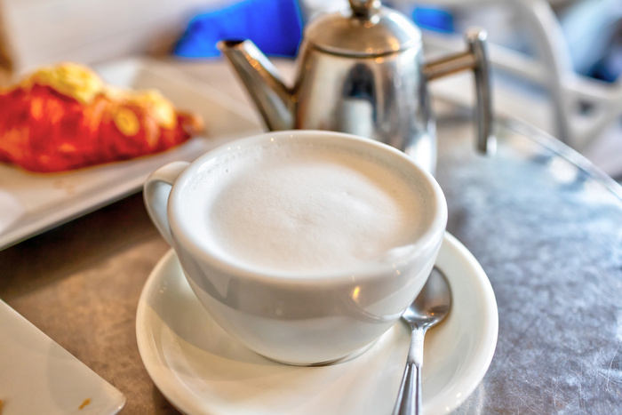 Focus on hot London Fog tea latte drink with foamed milk